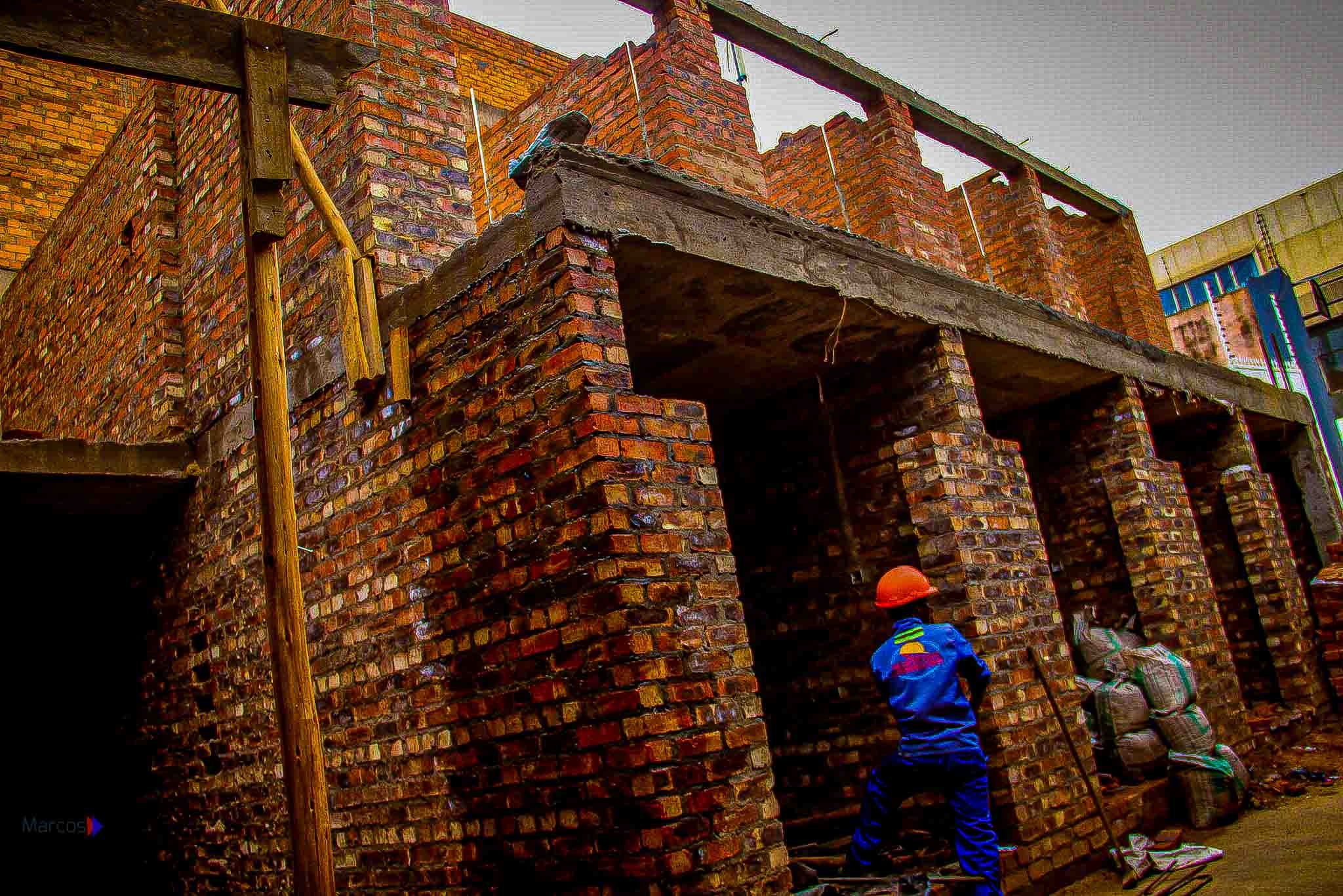 Martcosy Construction site worker in safety gear on a masonry build